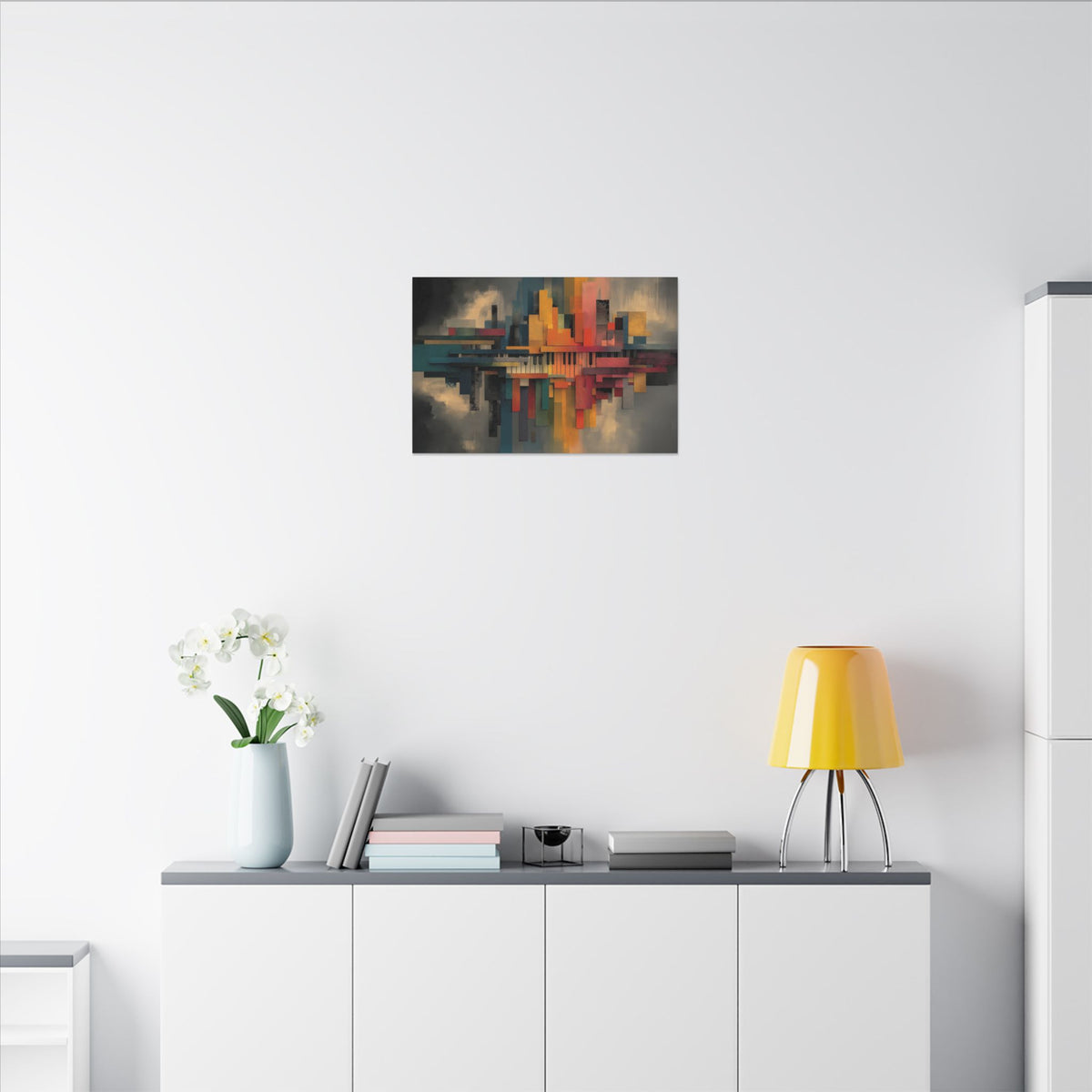 City Geometry canvas above a white sideboard with a yellow lamp and white flowers