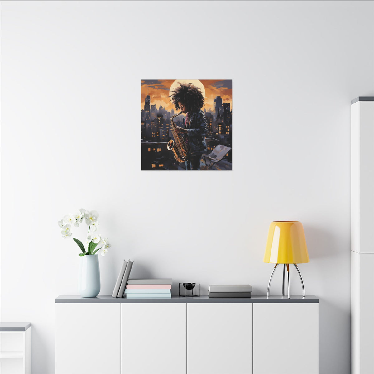 Black Child Saxophonist canvas above a white sideboard beside a yellow lamp and books