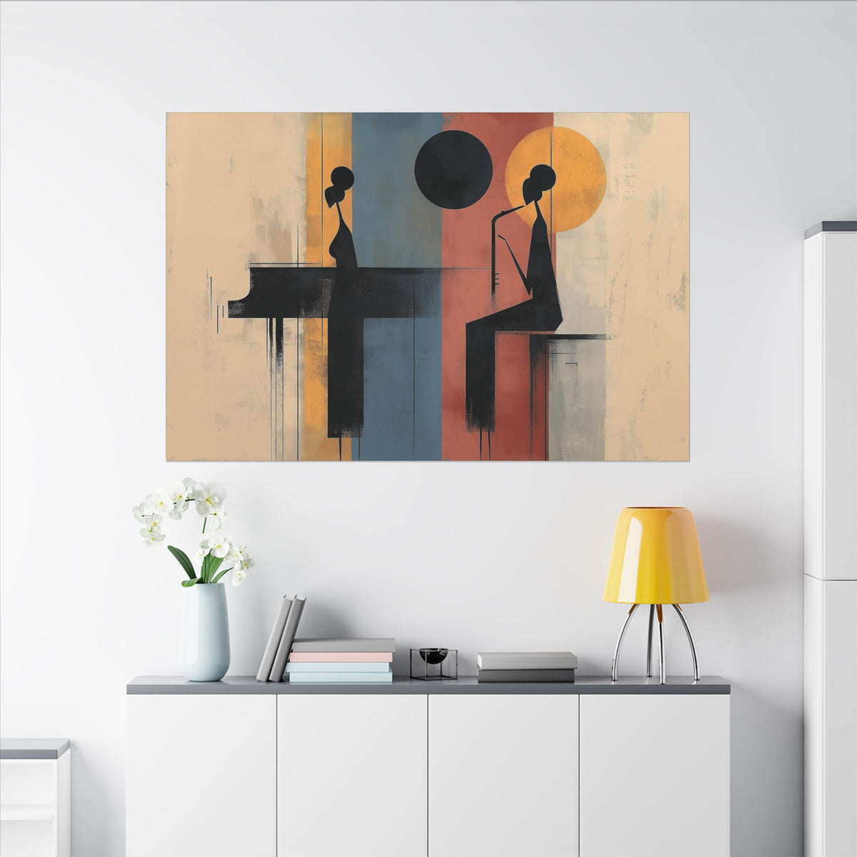 Piano Duo canvas above a white sideboard with a yellow lamp and white flowers